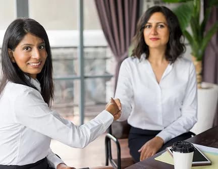 HR representative shaking hands to confirm a job offer